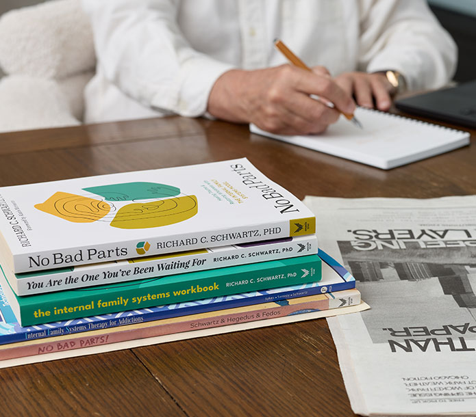 Dr. Richard C. Schwartz at his desk with books